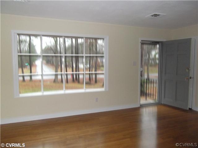 7731 Varann Road Henrico, VA 23231 - Photo 5 of 24 a view of an empty room with wooden floor and a window