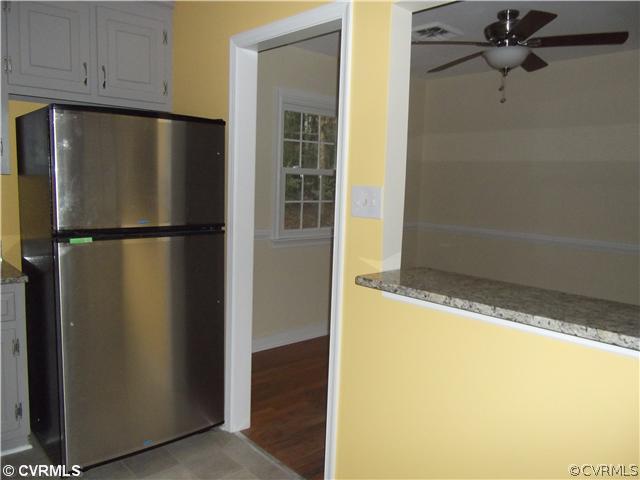 7731 Varann Road Henrico, VA 23231 - Photo 8 of 24 a view of a refrigerator in kitchen and an empty room