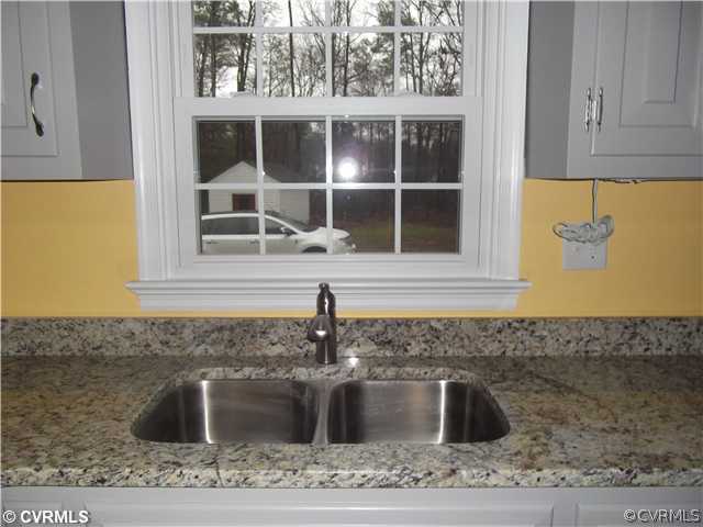 7731 Varann Road Henrico, VA 23231 - Photo 10 of 24 a kitchen with a sink and granite counter top