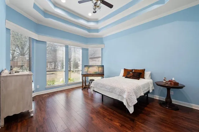 a bedroom with furniture and a large window