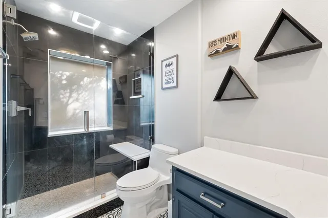 a bathroom with a toilet sink and a shower