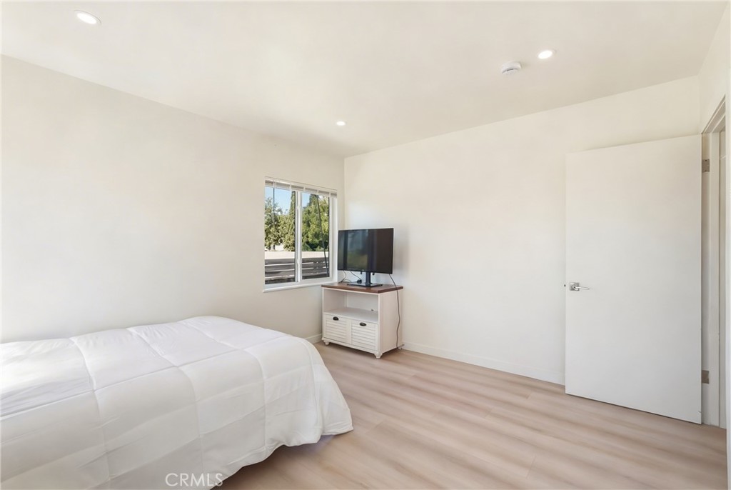 910 Arwin Street Pasadena, CA 91001 - Photo 12 of 23 a bedroom with a bed and a flat screen tv