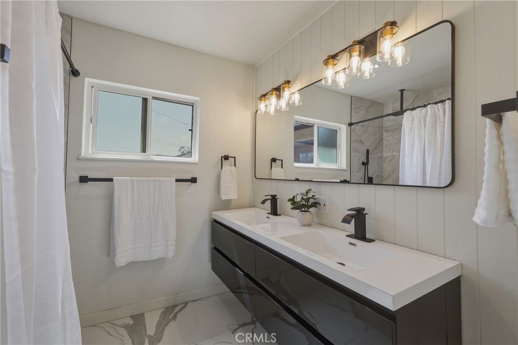 910 Arwin Street Pasadena, CA 91001 - Photo 13 of 23 a bathroom with a sink vanity and a mirror