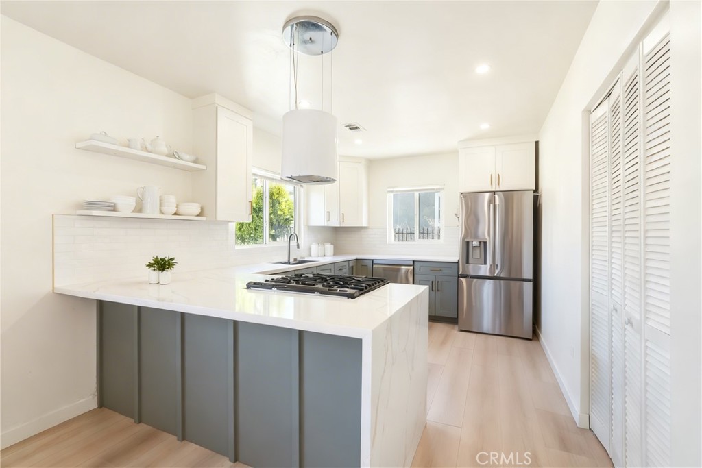 910 Arwin Street Pasadena, CA 91001 - Photo 4 of 23 a kitchen with stainless steel appliances a refrigerator a stove a sink and a refrigerator