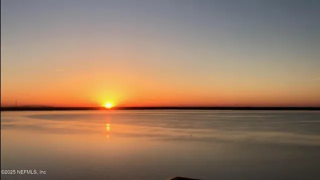 a sign board with buildings in the background