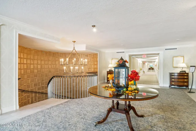 a view of entryway bedroom and hall with wooden floor