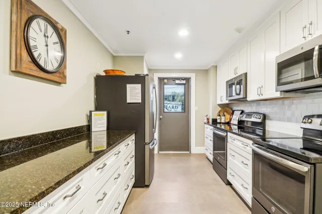 a view of a a dining room with furniture and a book shelf
