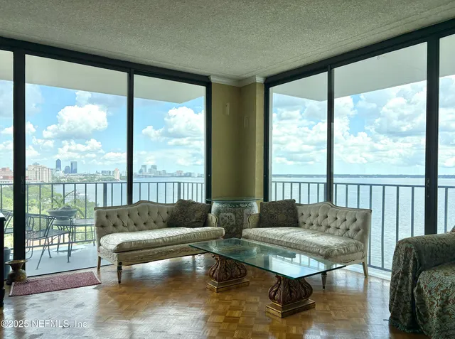 a living room with furniture and a floor to ceiling window