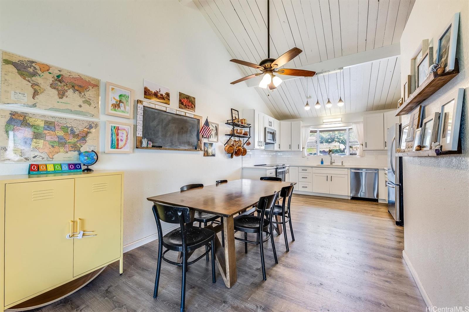 a view of a dining room with furniture and a kitchen