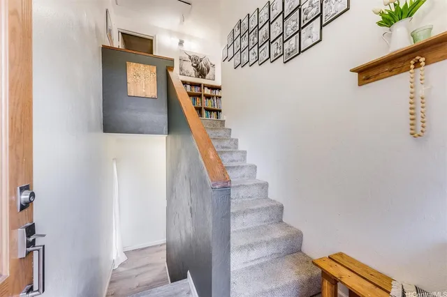 a view of entryway and hall with wooden floor