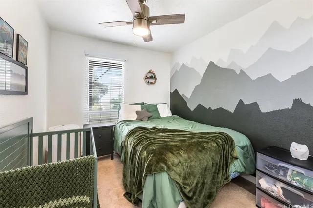 a bed sitting in a bedroom next to a window