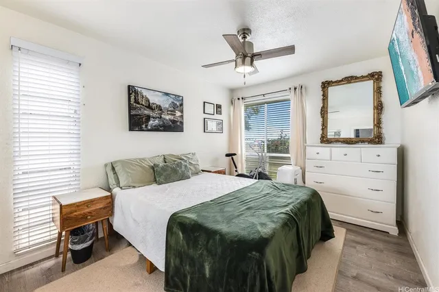a bedroom with a large bed and a window