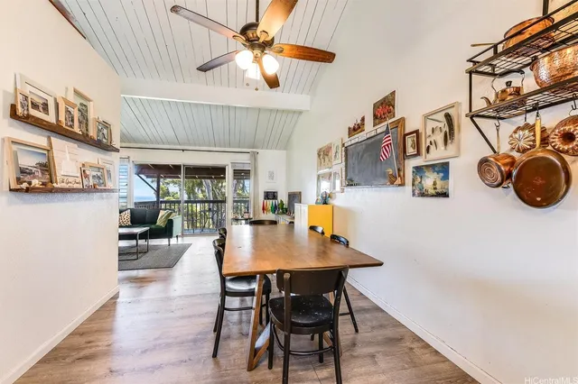 a view of a dining room with furniture and a chandelier fan