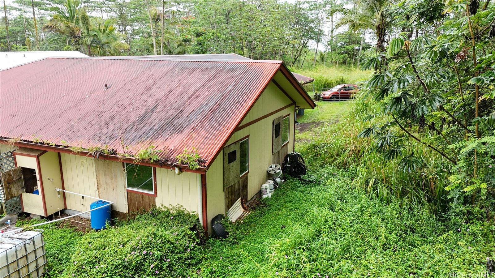 16-1998 Tiki Road Pahoa, HI 96778 - Photo 3 of 8 a aerial view of a house with table and chairs under an umbrella