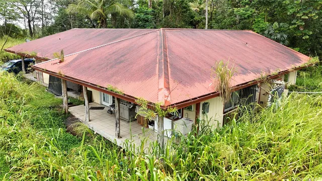 a view of a small house with a yard