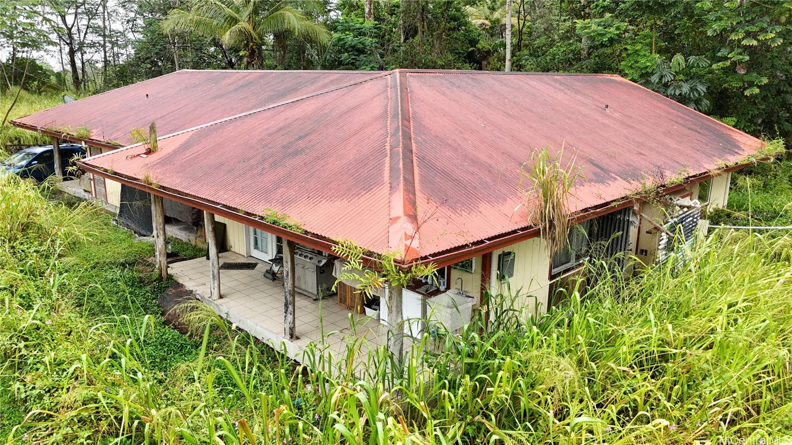 16-1998 Tiki Road Pahoa, HI 96778 - Photo 4 of 8 a view of a small house with a yard