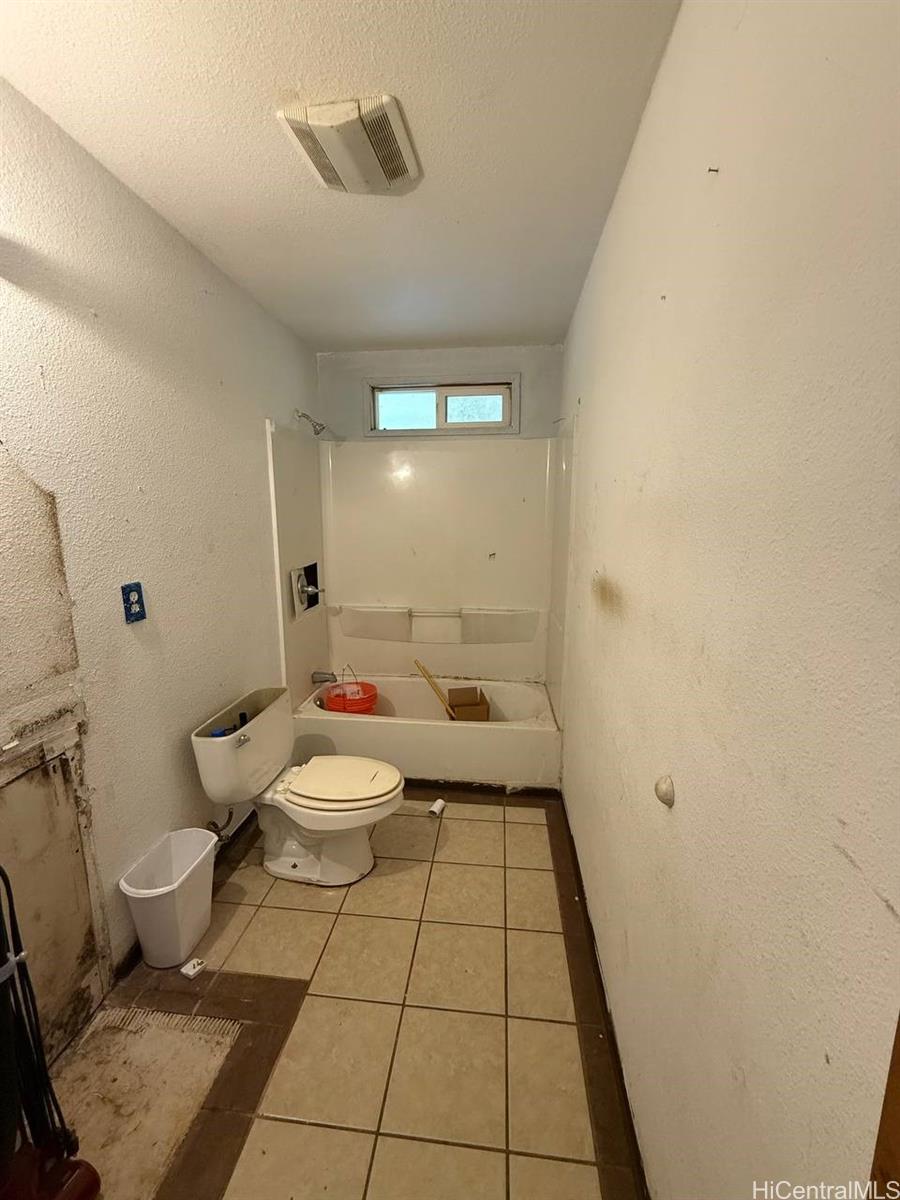 16-1998 Tiki Road Pahoa, HI 96778 - Photo 6 of 8 a bathroom with a toilet and a shower