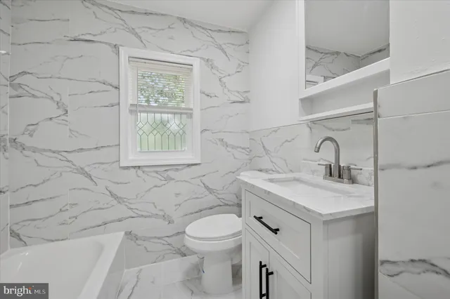 a bathroom with a sink toilet and vanity