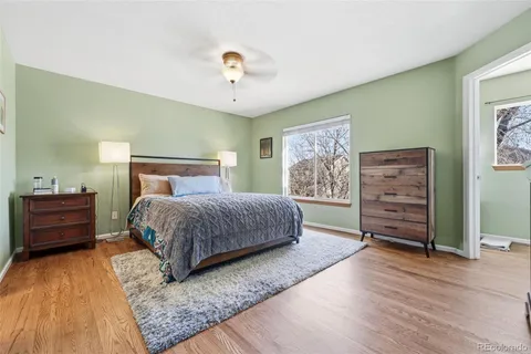 a bedroom with a bed and wooden floor
