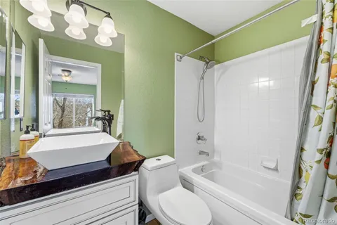 a bathroom with a sink a toilet and bathtub