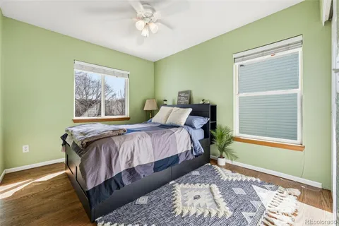 a bedroom with a bed lamp and a window