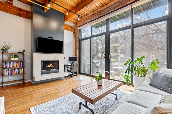 a living room with furniture a bookshelf and a fireplace