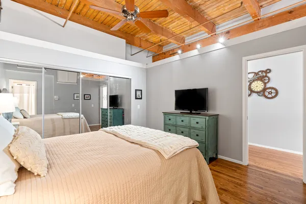 a bedroom with a bed and a flat screen tv