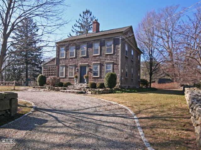 121 Millstone Road Wilton, CT 06897 - Photo 1 of 1 a view of a house with snow on the road