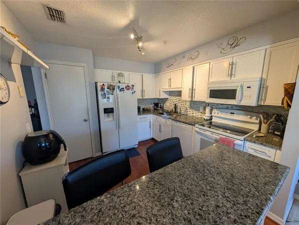 a kitchen with a table and chairs