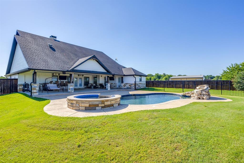 733 Fm 2652 Graham, TX 76450 - Photo 25 of 40 a view of a swimming pool with a table and chairs under an umbrella