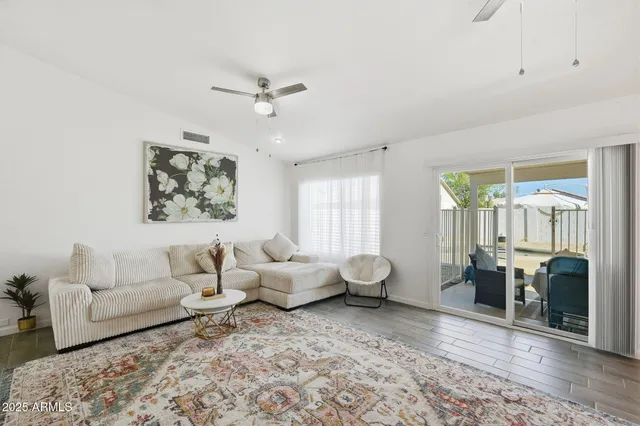a living room with furniture and wooden floor