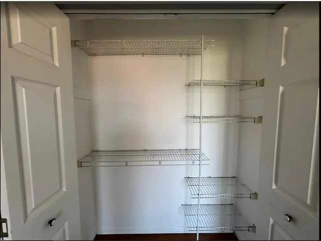 a view of storage and utility room with racks on the wall