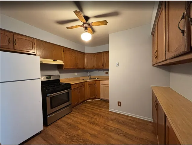 a kitchen with a refrigerator stove and cabinets