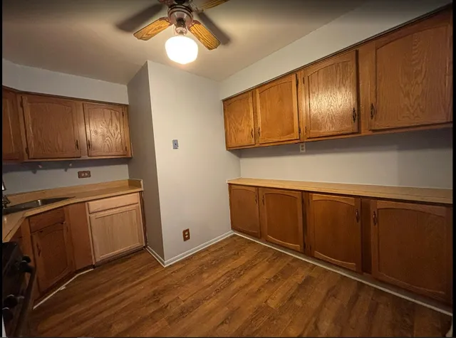 a kitchen with wooden cabinets and center island