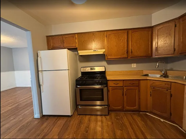 a kitchen with a refrigerator sink and cabinets