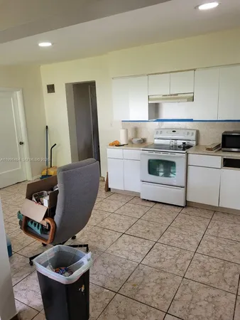 a kitchen with stainless steel appliances granite countertop a refrigerator a stove and a sink with dishwasher