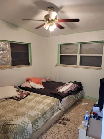 a bedroom with a bed and a flat tv screen