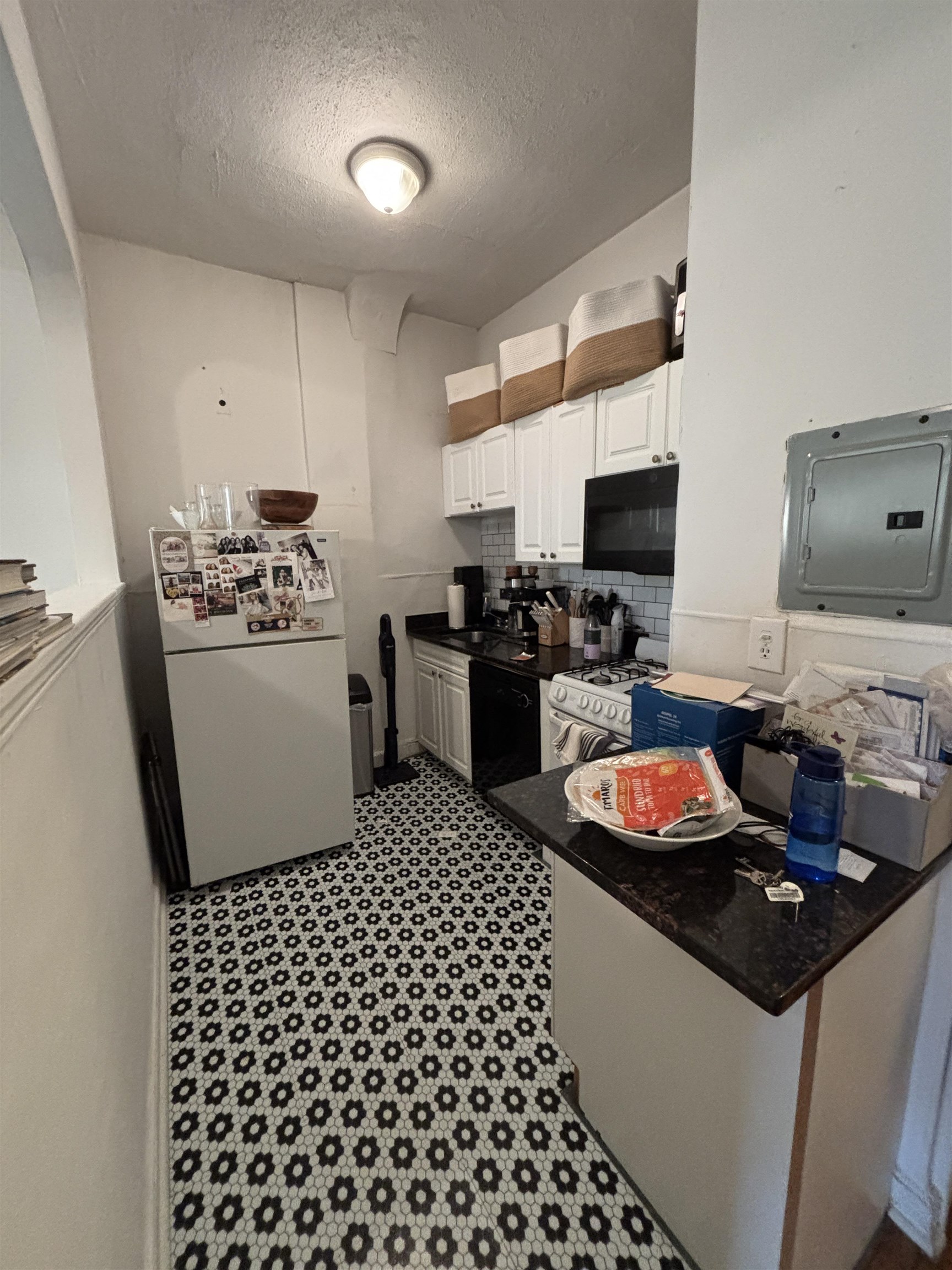 410 Washington Street, Unit 7 Hoboken, NJ 07030 - Photo 2 of 6 a kitchen with a sink a stove and wooden cabinets