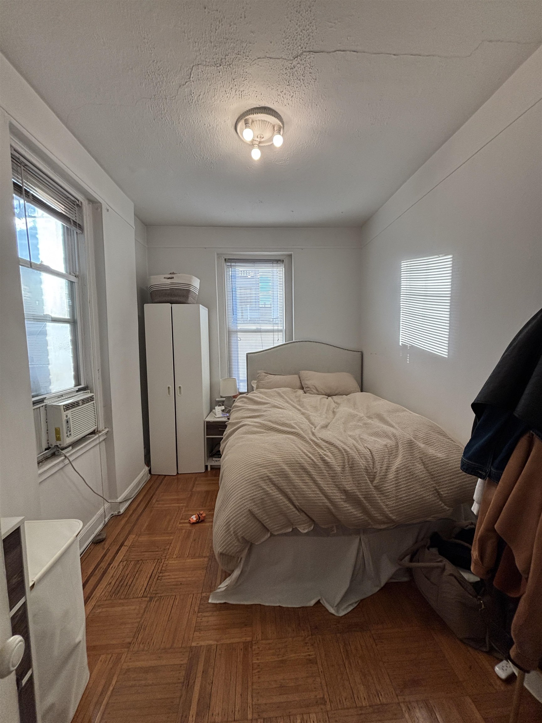 410 Washington Street, Unit 7 Hoboken, NJ 07030 - Photo 3 of 6 a spacious bedroom with a bed and a window