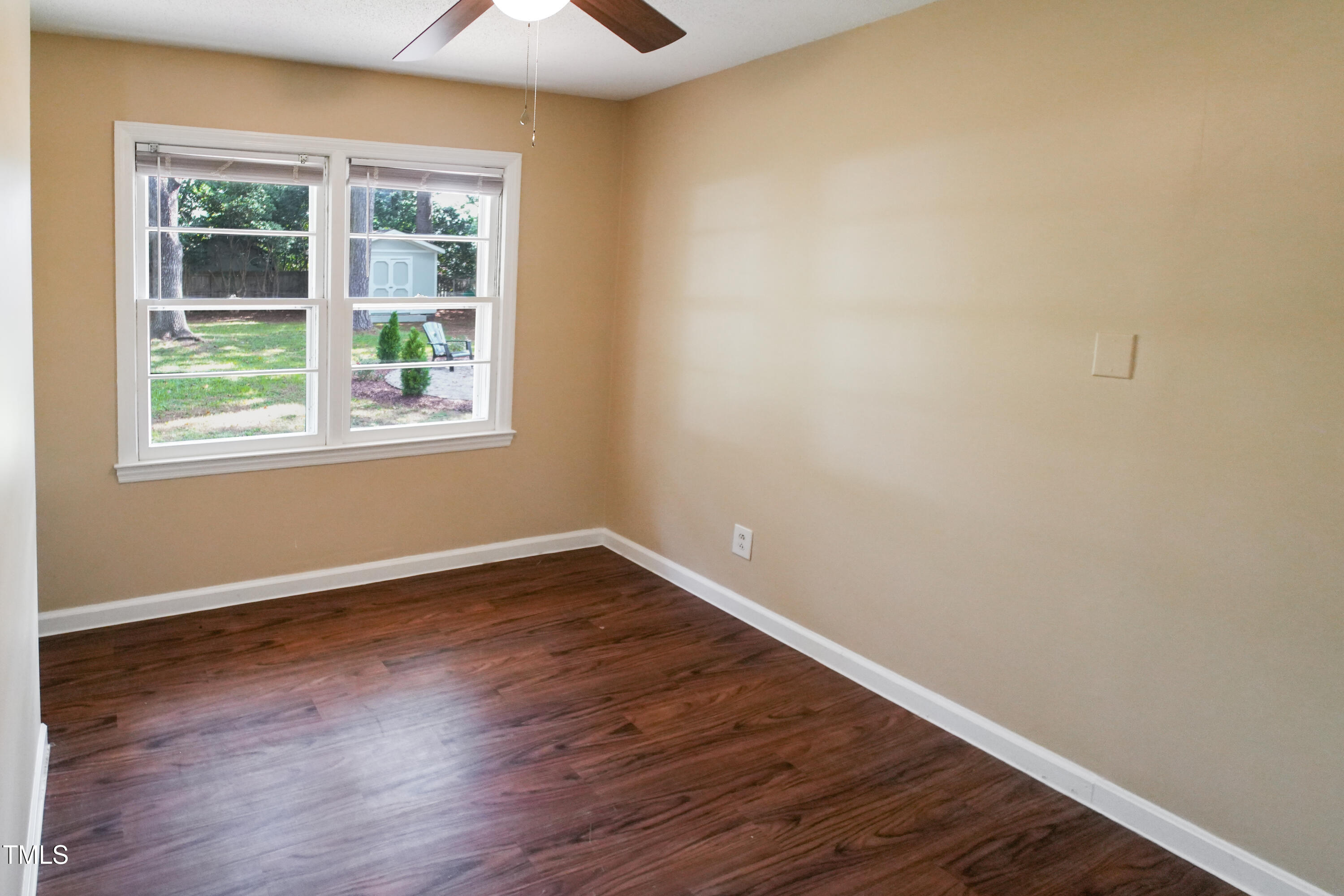 607 Nellane Drive Garner, NC 27529 - Photo 15 of 35 an empty room with wooden floor and windows