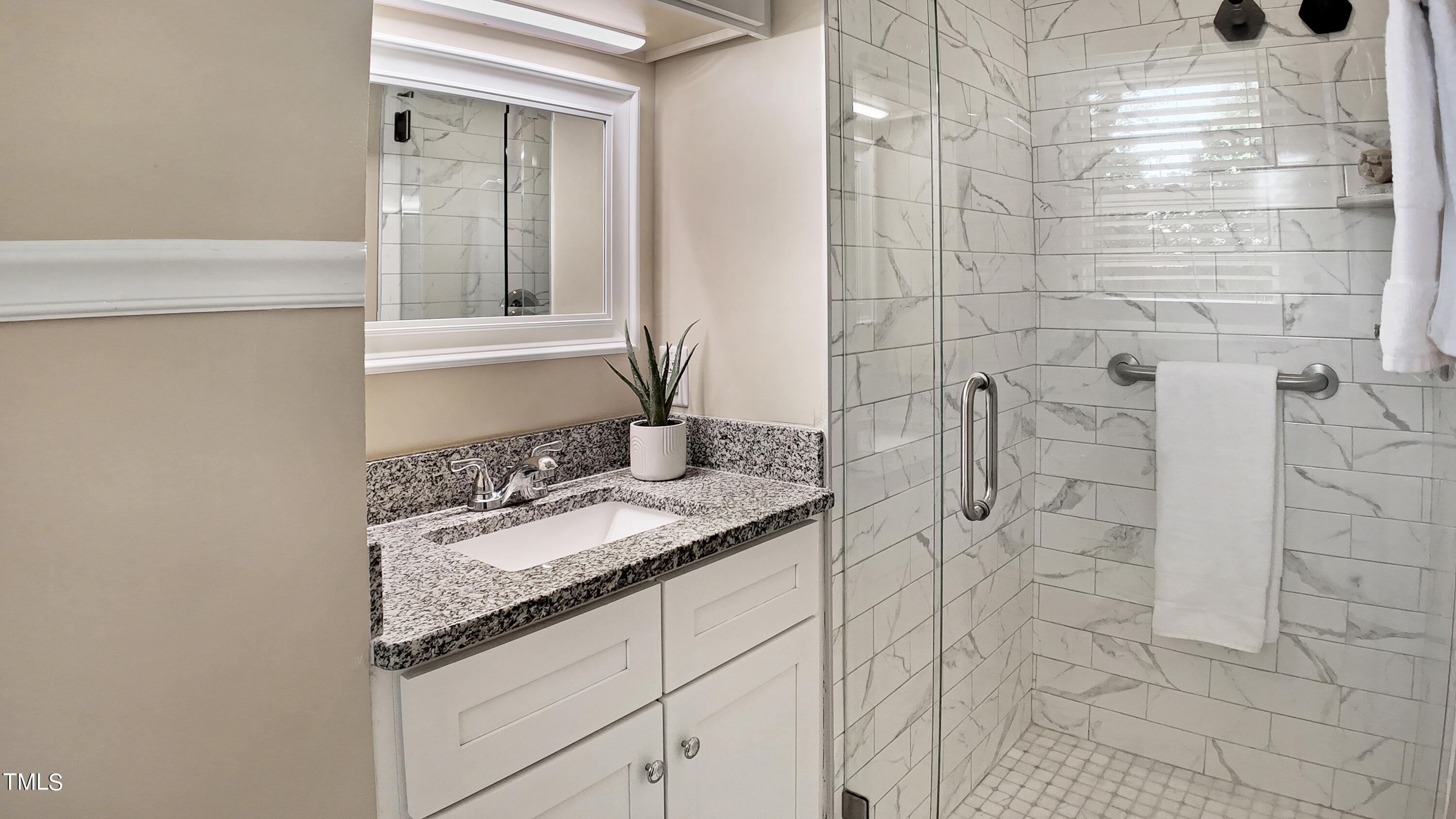 607 Nellane Drive Garner, NC 27529 - Photo 21 of 35 a bathroom with a granite countertop shower a sink and vanity