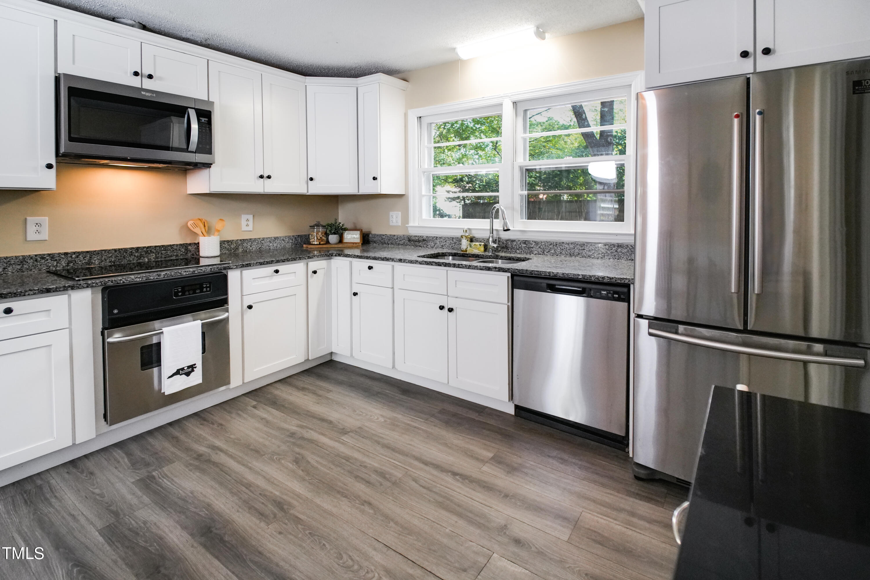 607 Nellane Drive Garner, NC 27529 - Photo 10 of 35 a kitchen with stainless steel appliances granite countertop a refrigerator sink and microwave