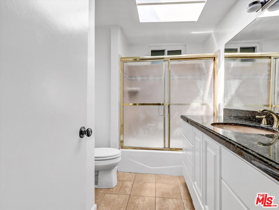 12479 Walsh Avenue Los Angeles, CA 90066 - Photo 13 of 21 a bathroom with a granite countertop sink a toilet and shower