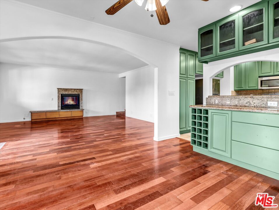 12479 Walsh Avenue Los Angeles, CA 90066 - Photo 4 of 21 a room with a wooden floor and chandelier