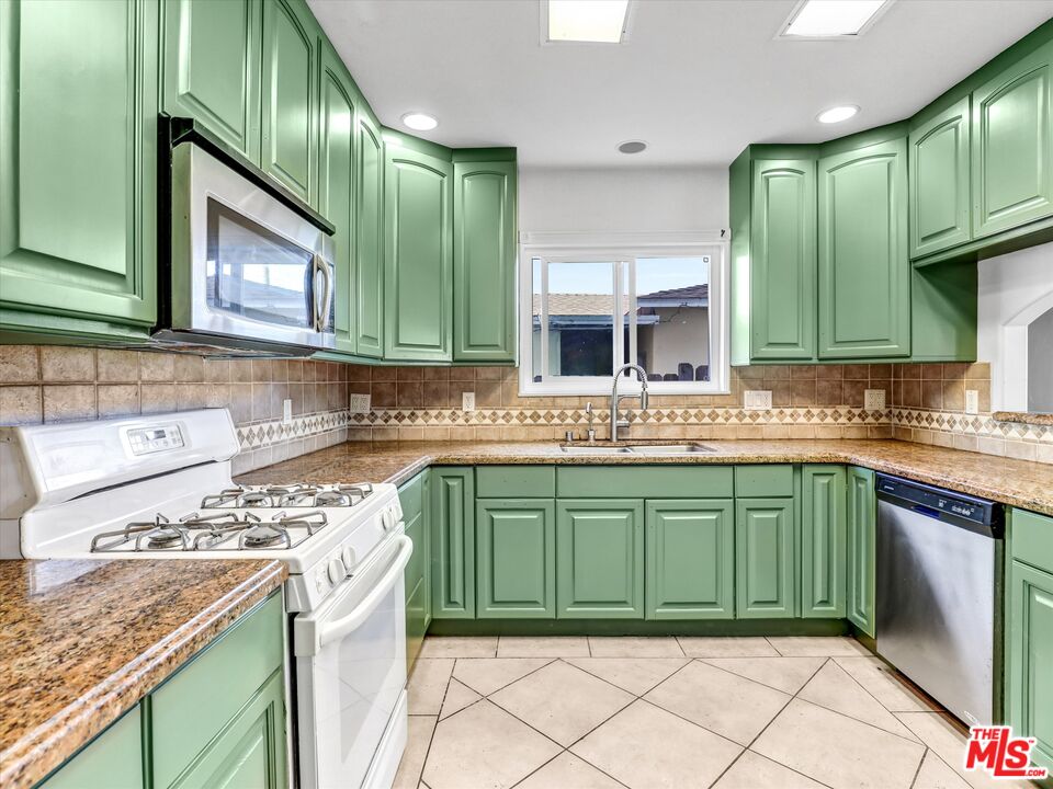 12479 Walsh Avenue Los Angeles, CA 90066 - Photo 6 of 21 a kitchen with a sink stove top oven and cabinets