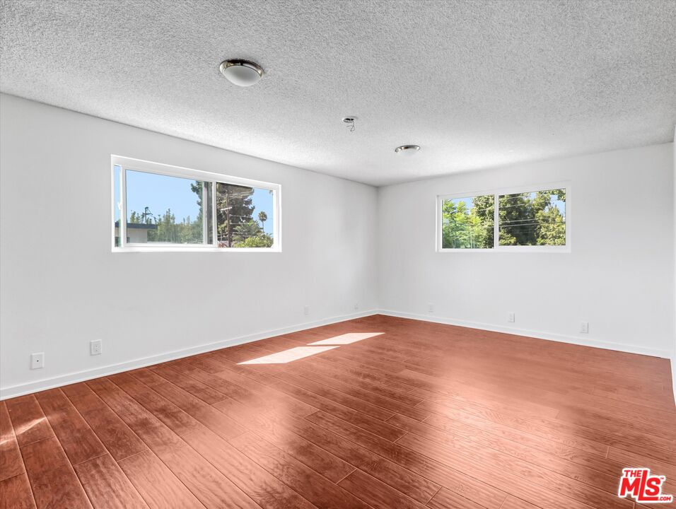 12479 Walsh Avenue Los Angeles, CA 90066 - Photo 9 of 21 a view of an empty room with wooden floor and a window