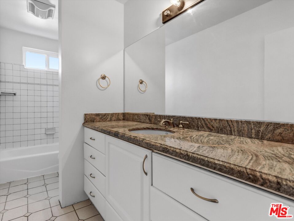 12479 Walsh Avenue Los Angeles, CA 90066 - Photo 10 of 21 a bathroom with a granite countertop sink and a bathtub