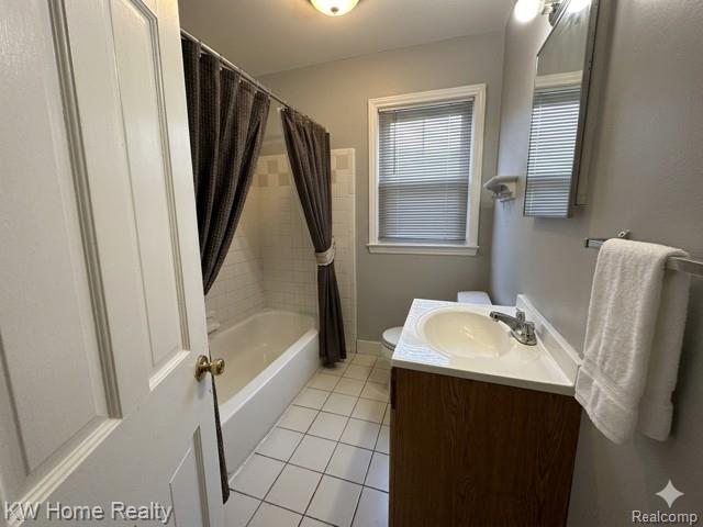 4607 Cadieux Road Detroit, MI 48224 - Photo 14 of 18 Full bath with vanity, light tile patterned floors, and shower / bath combo with shower curtain