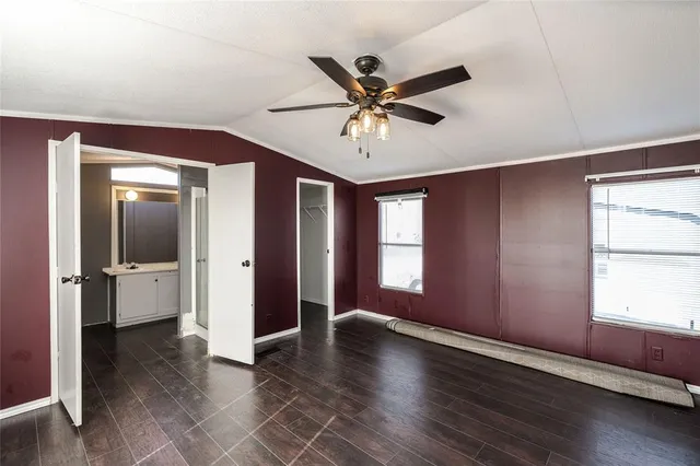 a view of a livingroom with a window and wooden floor