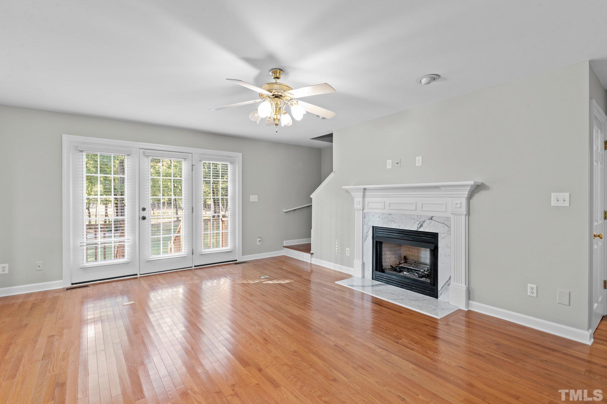 8025 Lockleair Road Zebulon, NC 27597 - Photo 13 of 30 Stairs are tucked behind fireplace wall and convenient to back French doors